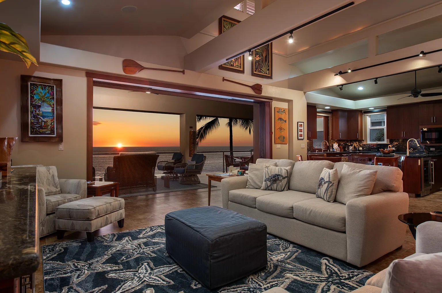 A Kailua-Kona great room opening to an oceanfront lanai at sunset