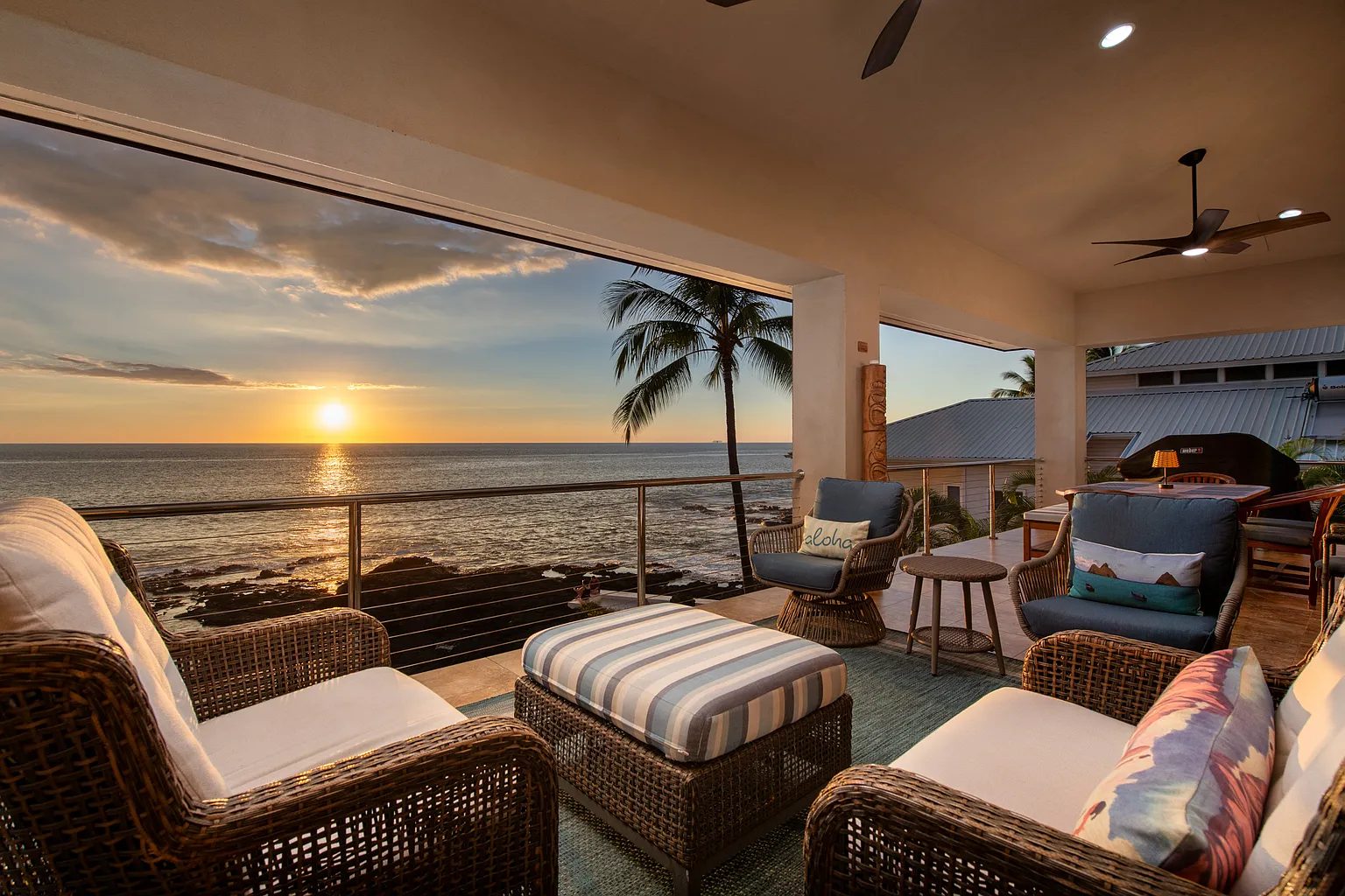Oceanfront lanai at sunset at a Kailua-Kona luxury home on Aliʻi Drive