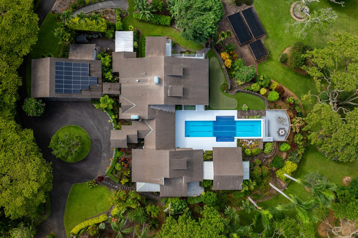 Aerial view of a Holualoa luxury estate with lap pool and tropical grounds