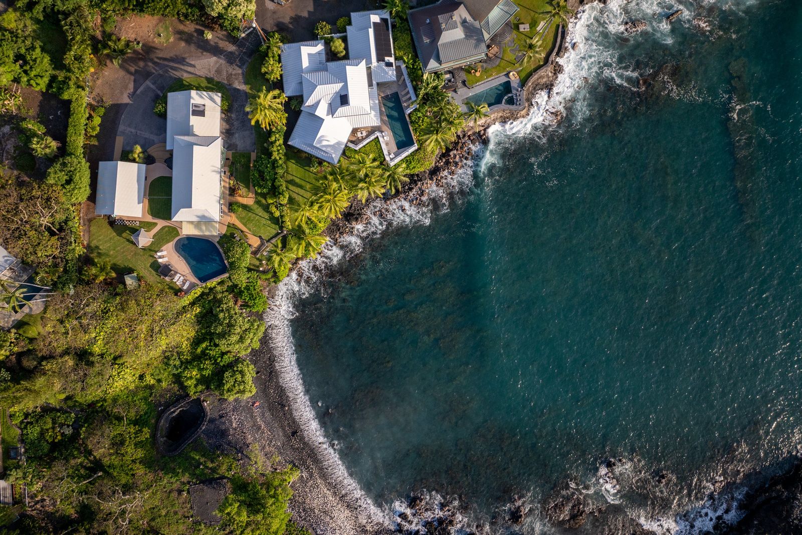 Aerial view of a private oceanfront estate on the Kona coast