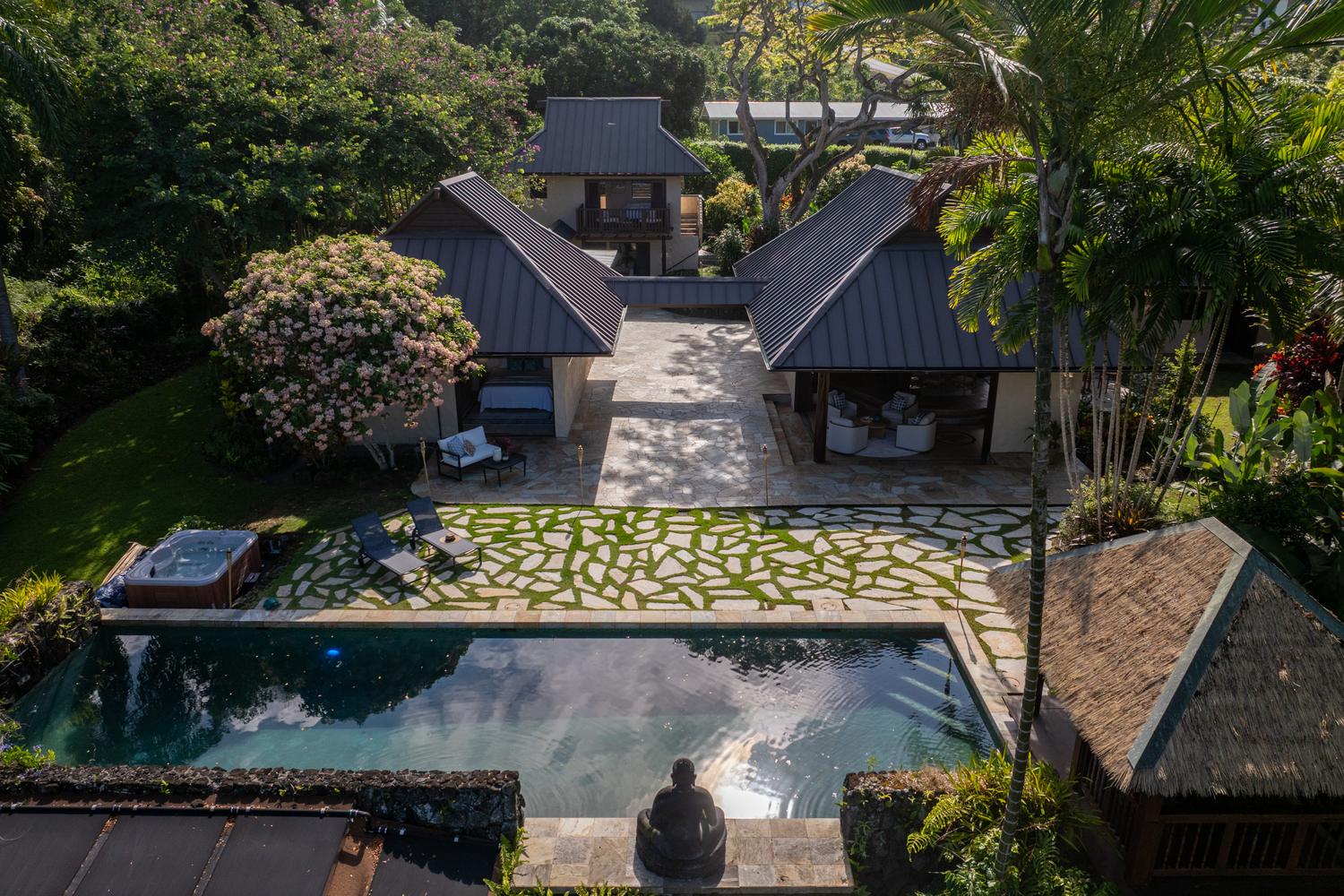 Aerial view of the pavilions, courtyard, and pool at Hale Lauleʻa in Holualoa, with the ocean beyond