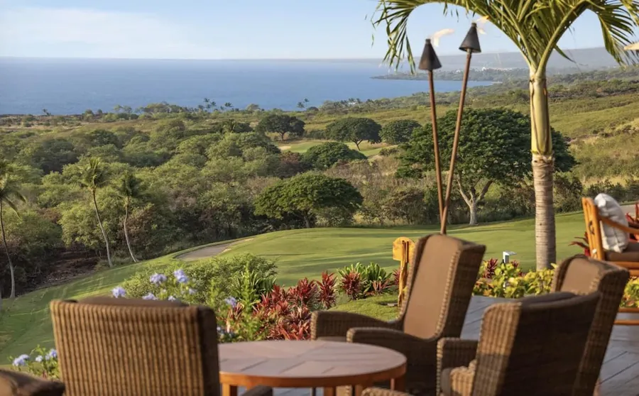 Lawn terrace and seating above the South Kona coastline at Hokulia, ocean stretching to the horizon