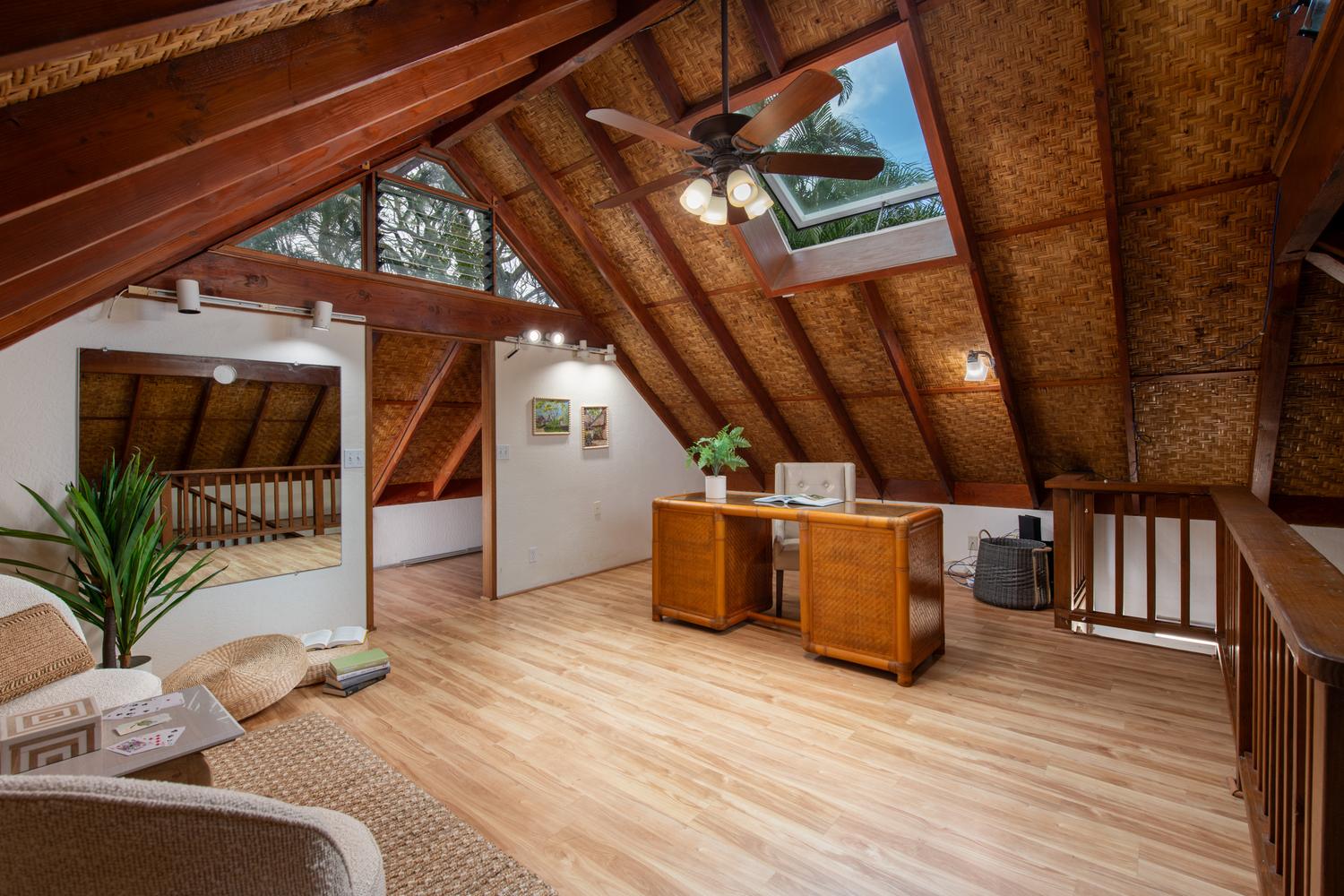 Vaulted loft office with skylight at a Holualoa luxury estate, set up for remote work